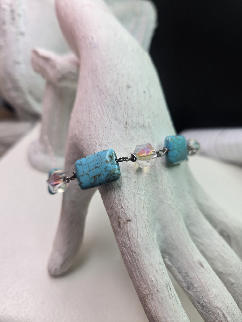 bracelet features square-cut turquoise beads linked with faceted crystal beads.